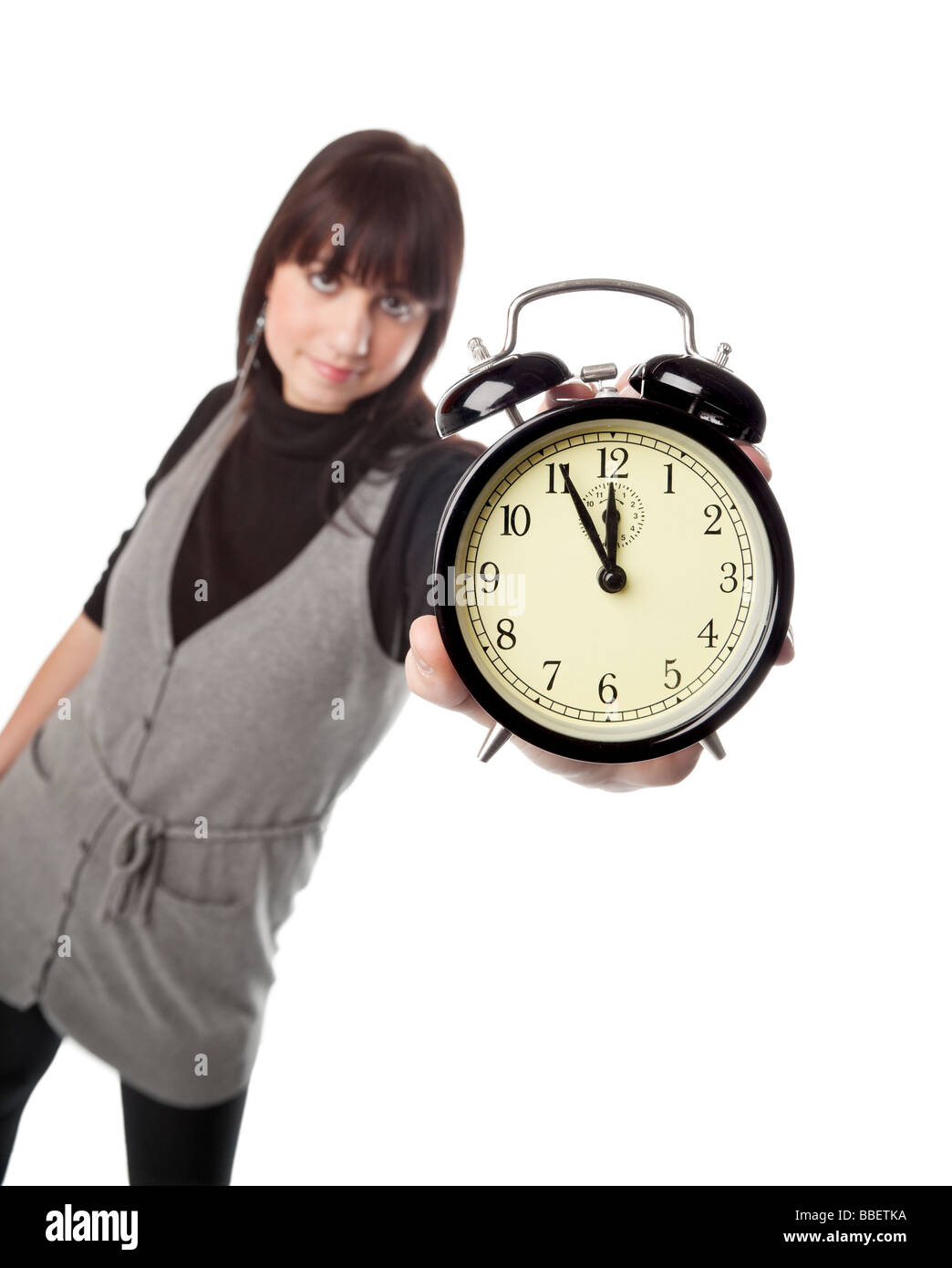 Pretty girl showing alarm clock Stock Photo Alamy
