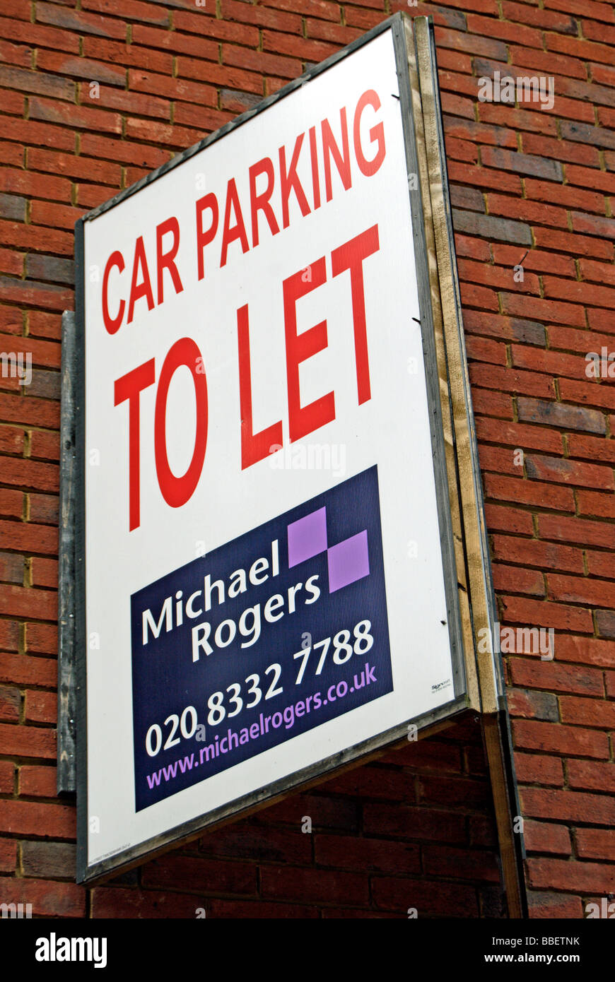 car parking to let sign on brick wall of a town centre building in ...