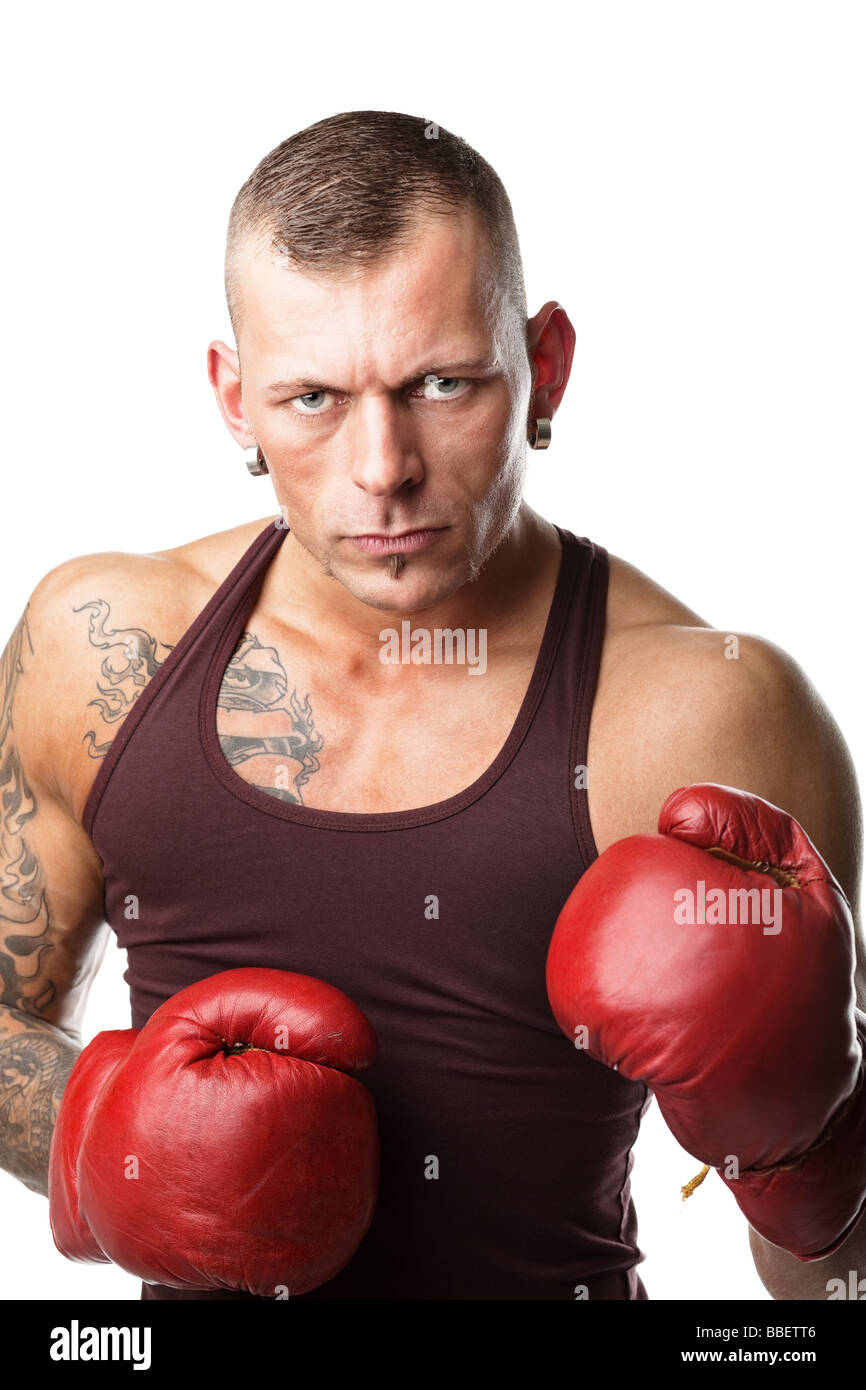 muscular young man in boxing gloves ready to fight Stock Photo