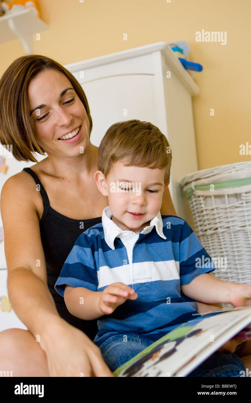 Mother and two year old son reading a book together, Milton, Ontario