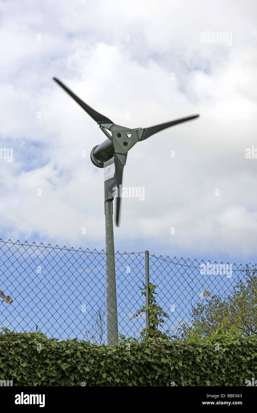 A small Wind Turbine in a fenced off area of a car park Stock Photo