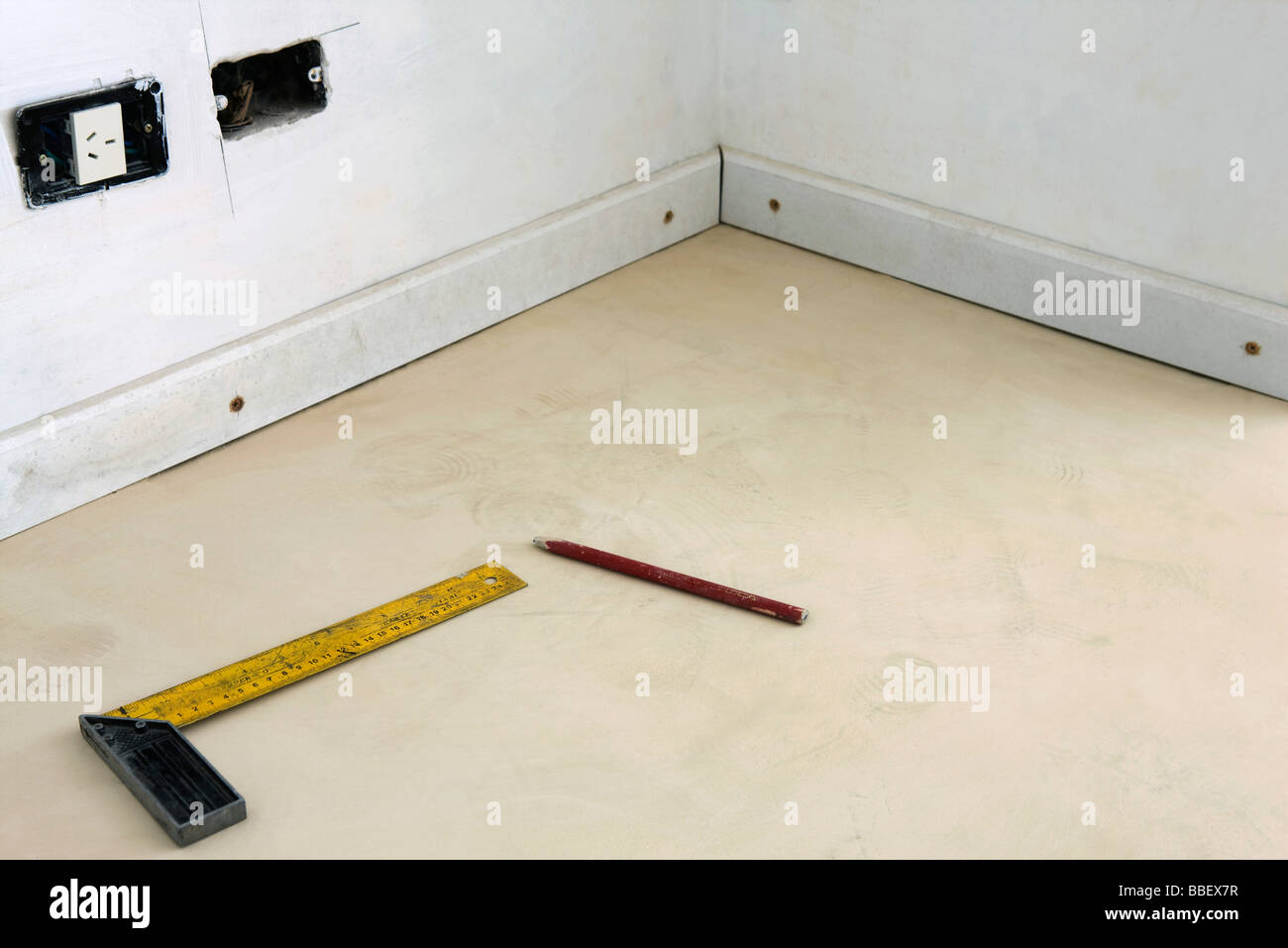 Tsquare, pencil on floor, unfinished electrical socket Stock Photo Alamy