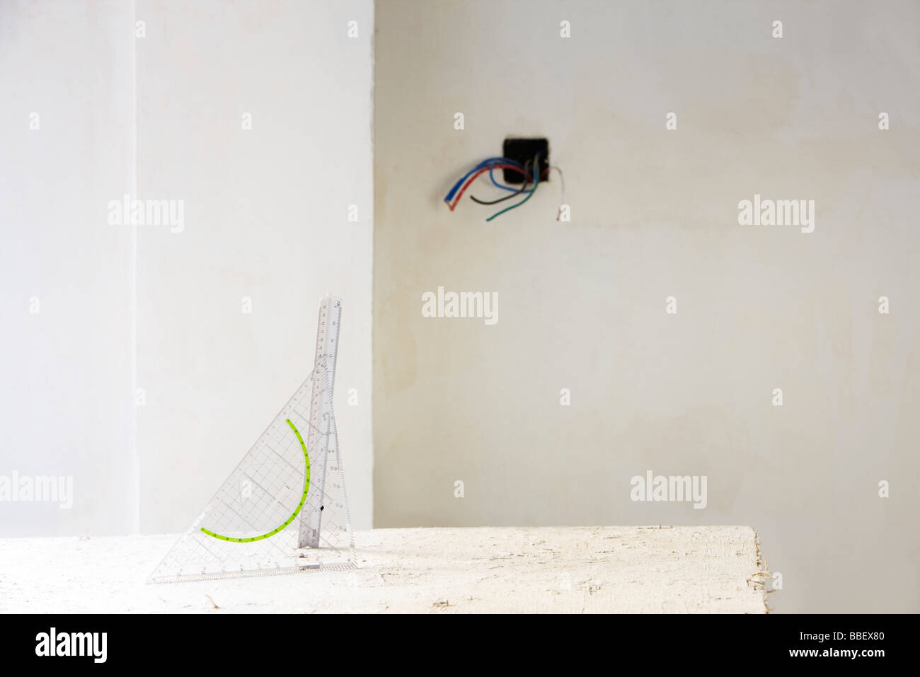 Set square, ruler on table in unfinished room Stock Photo - Alamy