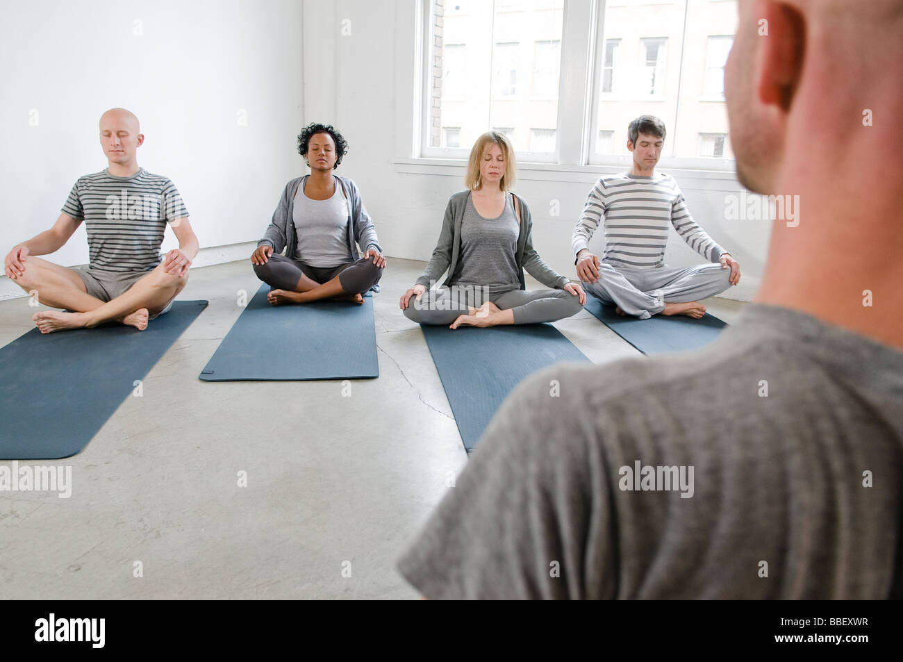 Students and instructor meditating in a yoga Class, Vancouver, British