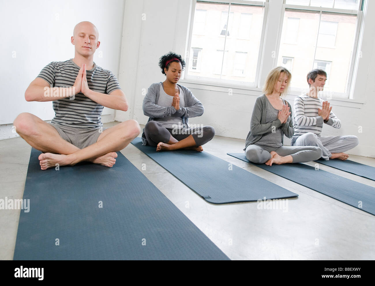 Students meditating in a yoga class, Vancouver, British Columbia Stock