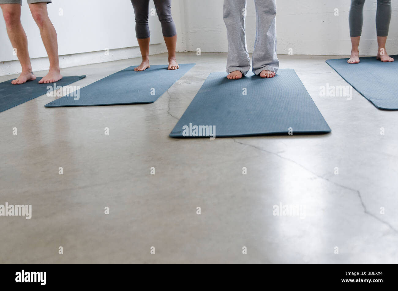 Detail of yoga students standing on mats, Vancouver, British Columbia