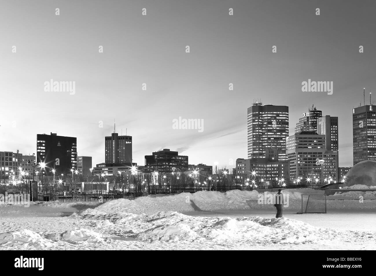 Skater at The Forks Winter Park and city skyline, Forks, Winnipeg, Manitoba Stock Photo