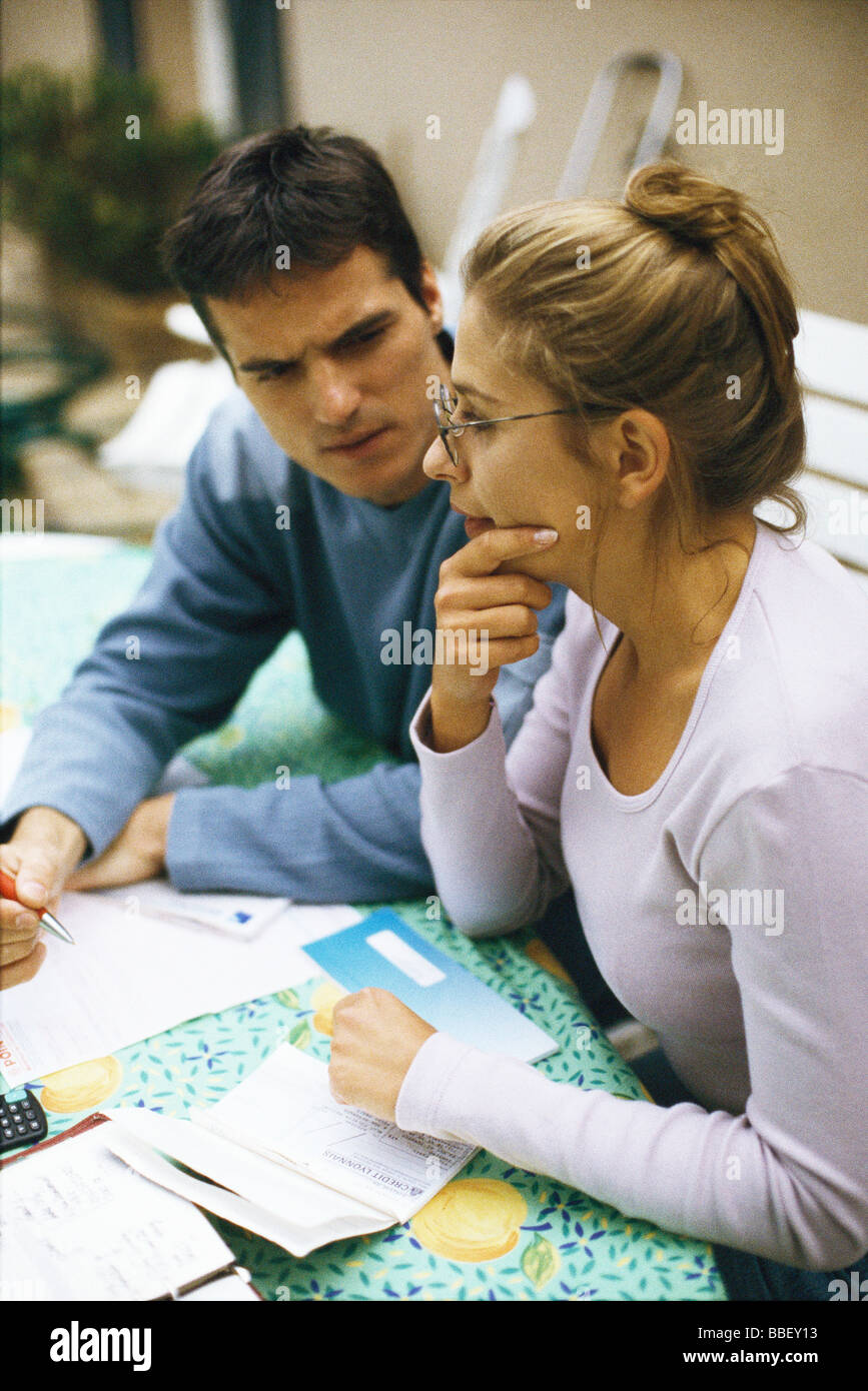 Couple sitting at table, discussing bills Stock Photo