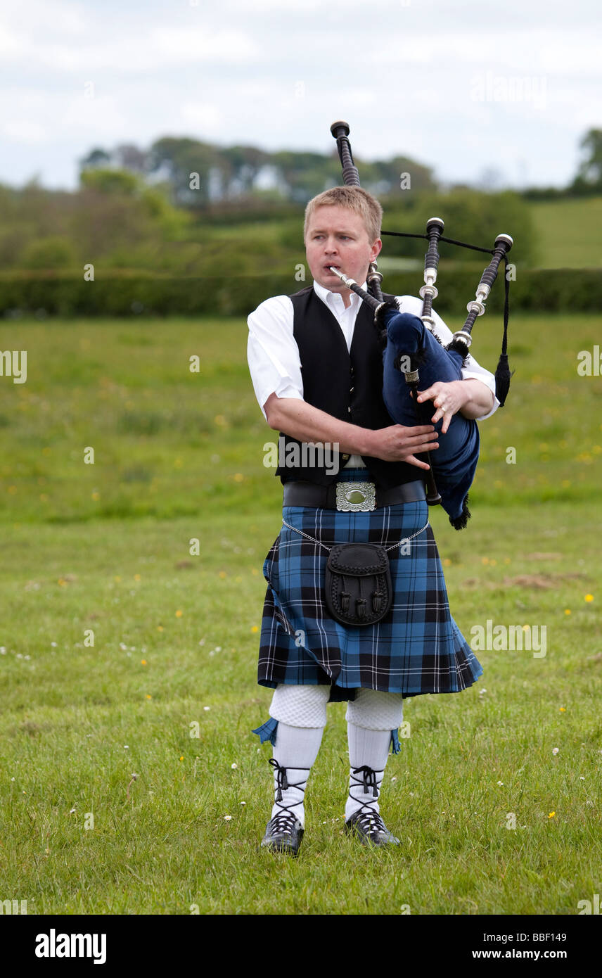 Solo piper playing the bagpipes Stock Photo