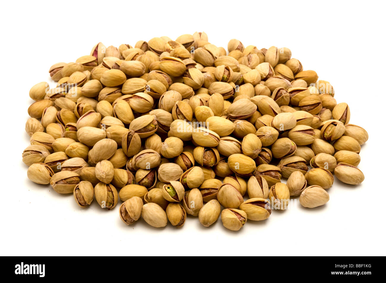 Salted roasted pistachios Pistacia vera on a white background Stock Photo