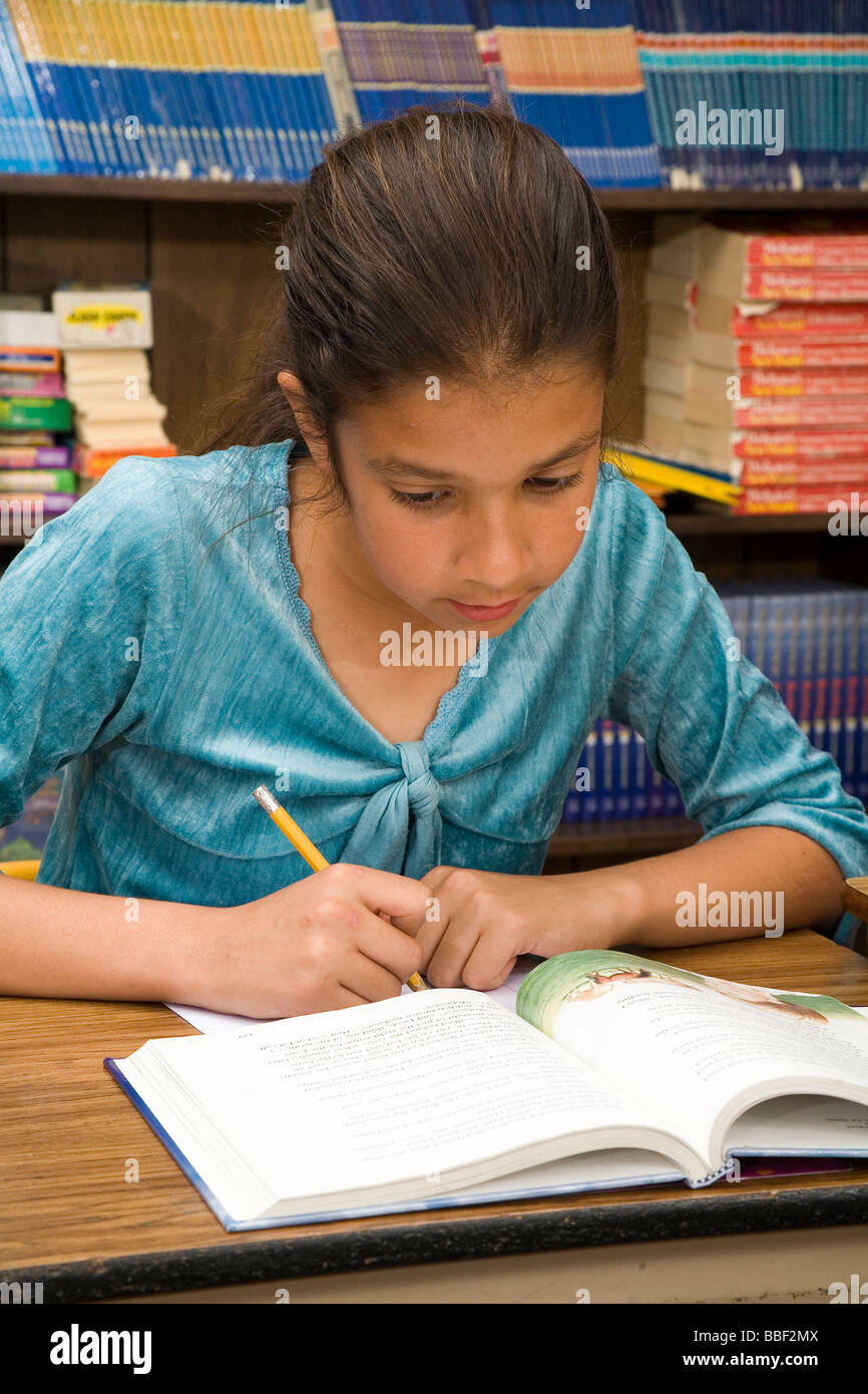 racially diverse   Girl  8-9 year old olds United States children studying reading read writing writes MR.  © Myrleen Pearson Stock Photo