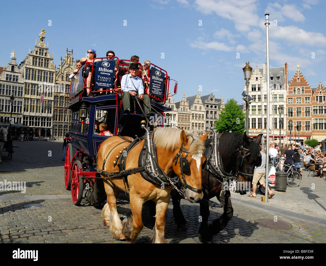 Horse-drawn carriage carrying tourists in Antwerp Grote Markt main square, Belgium Stock Photo