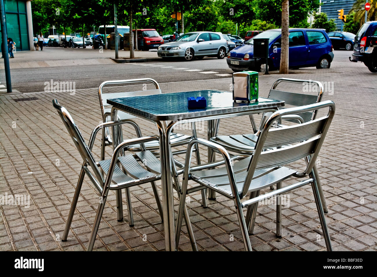Metal table and four metal chairs, outside a cafe bar in Diagonal Mar district of Barcelona. Stock Photo