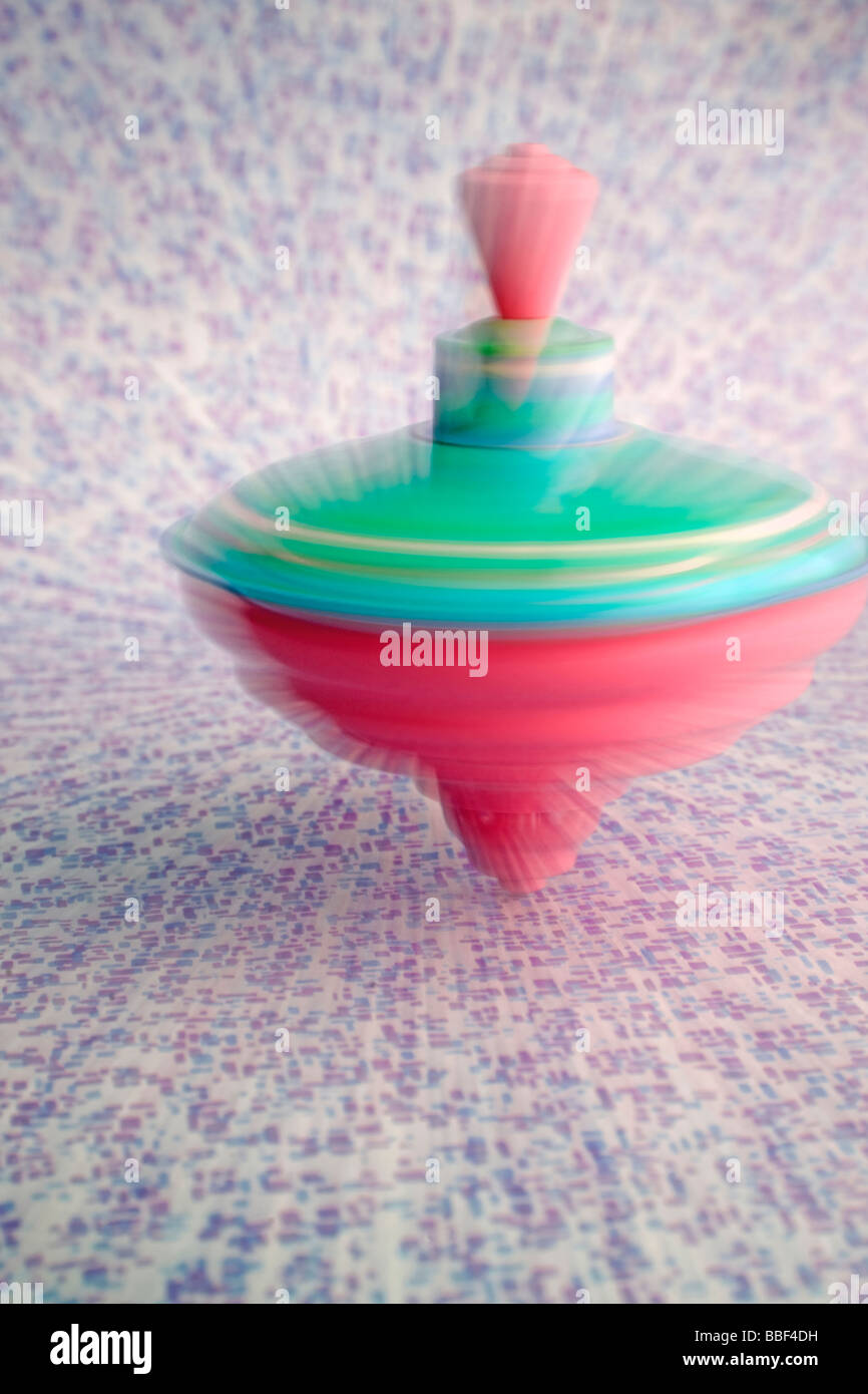 spinning top colorful toy fast moving dizzy equilibrium Stock Photo