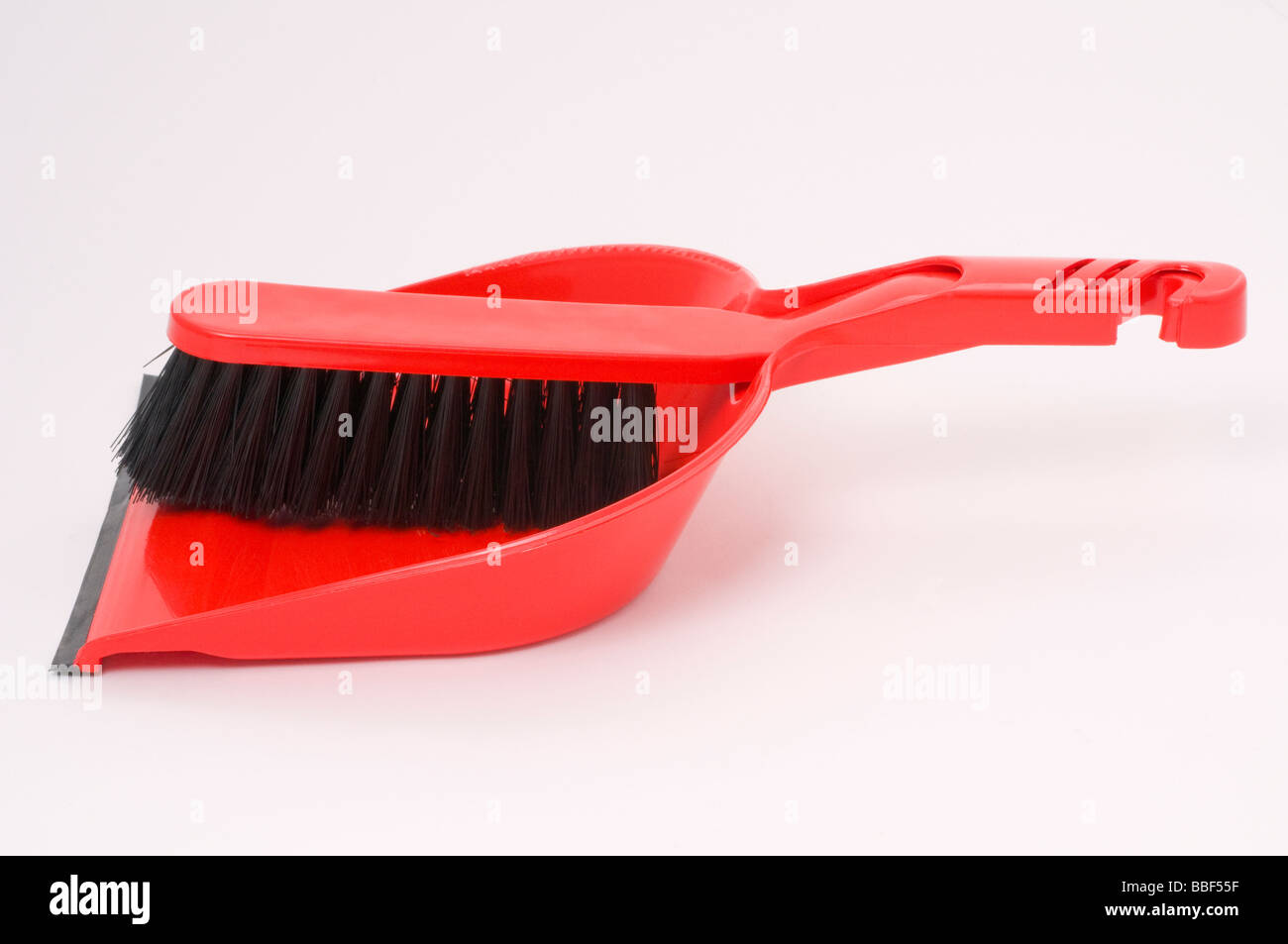 A red dust pan and brush Stock Photo