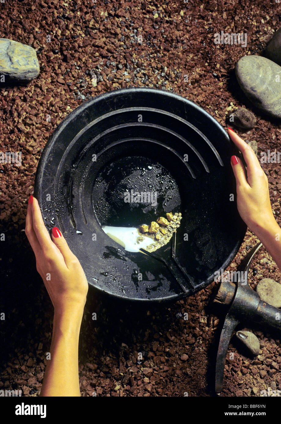 goldwasher model holding gold nuggets public relation photoshooting for goldsmith boutique Stock Photo