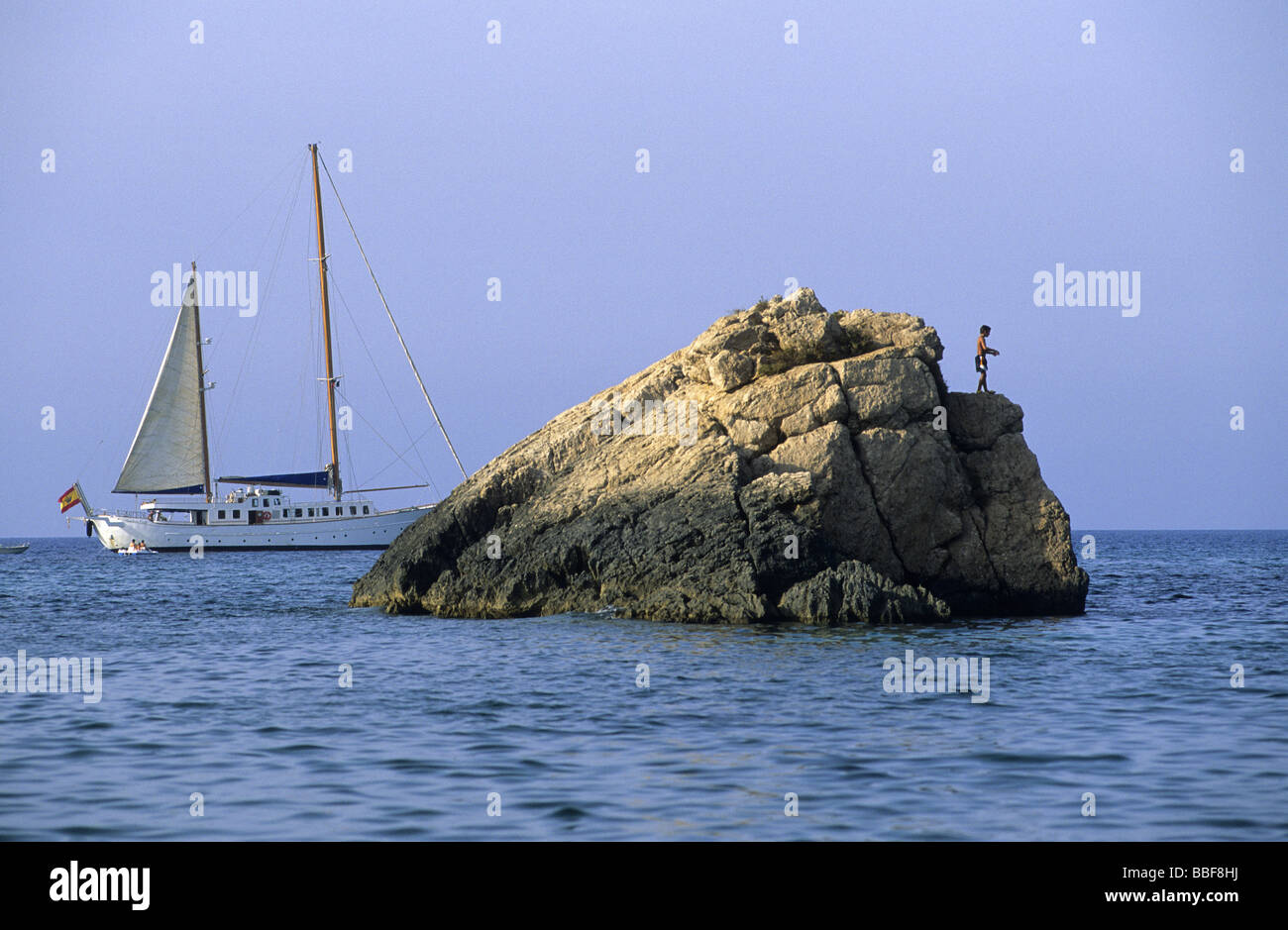 Sailboat and young boy Cala xarraca Ibiza island Balearic islands Spain Stock Photo