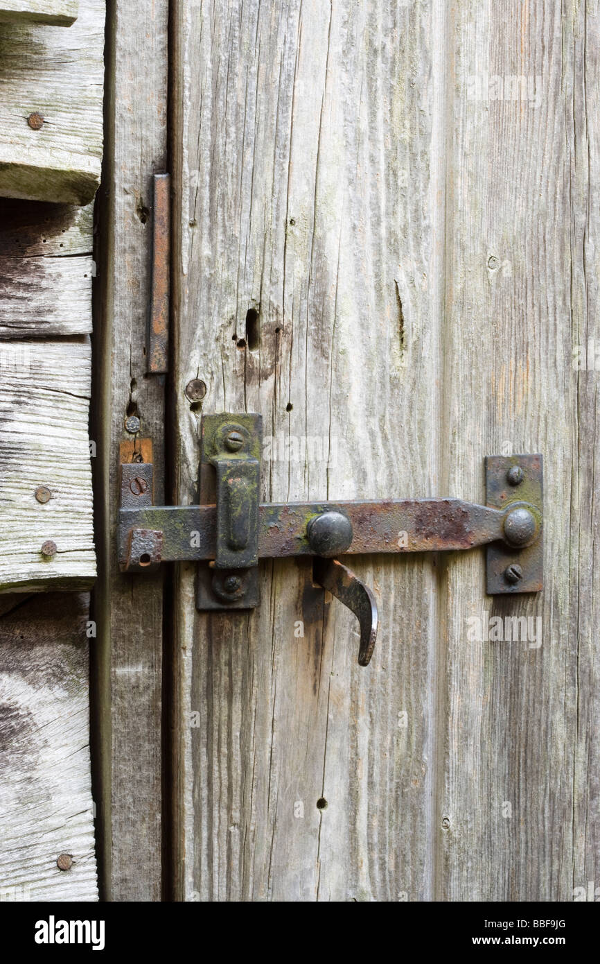 Latch and lock on old shed door. Stock Photo