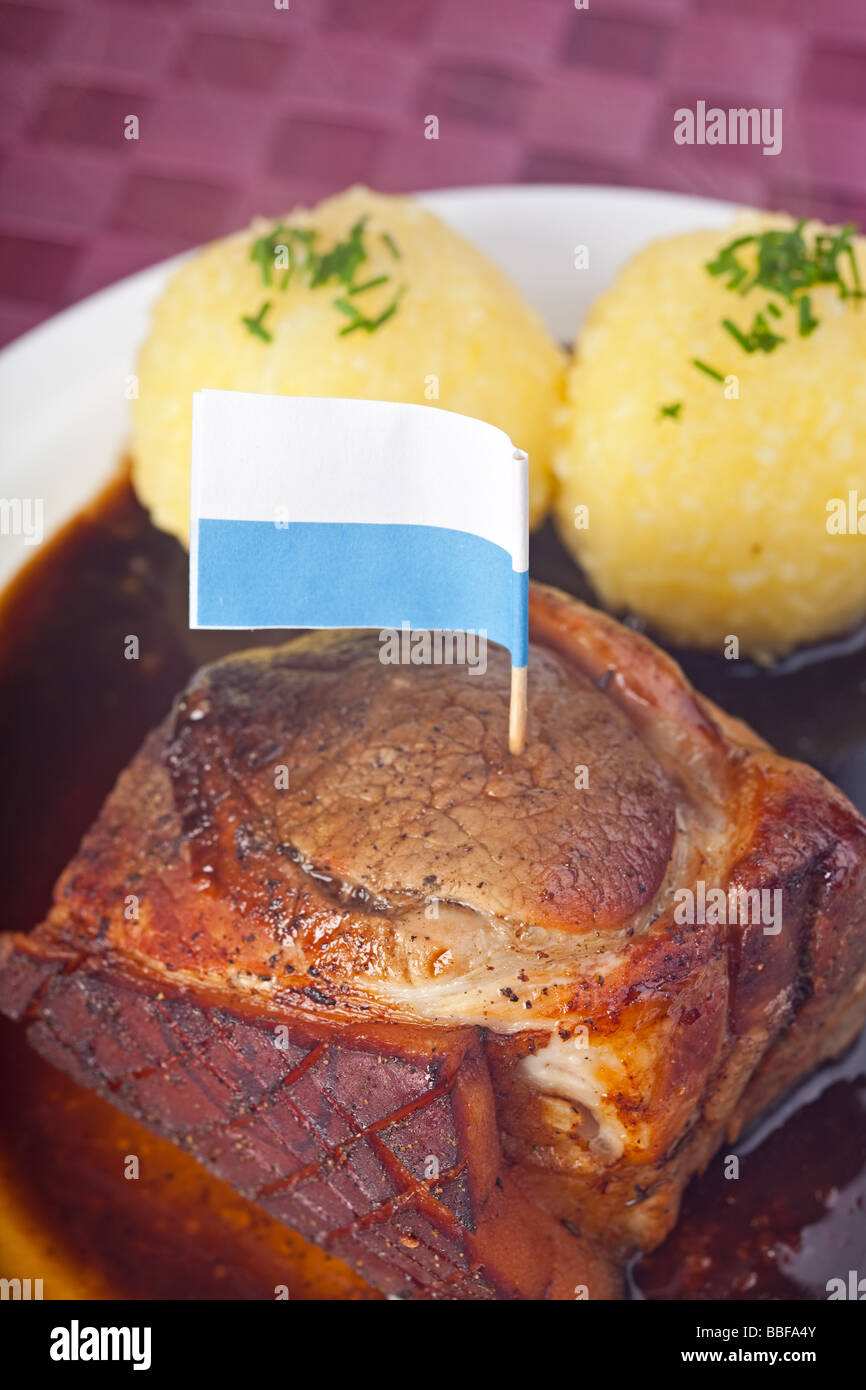 traditional bavarian roast pork with beer sauce and dumplings Stock Photo