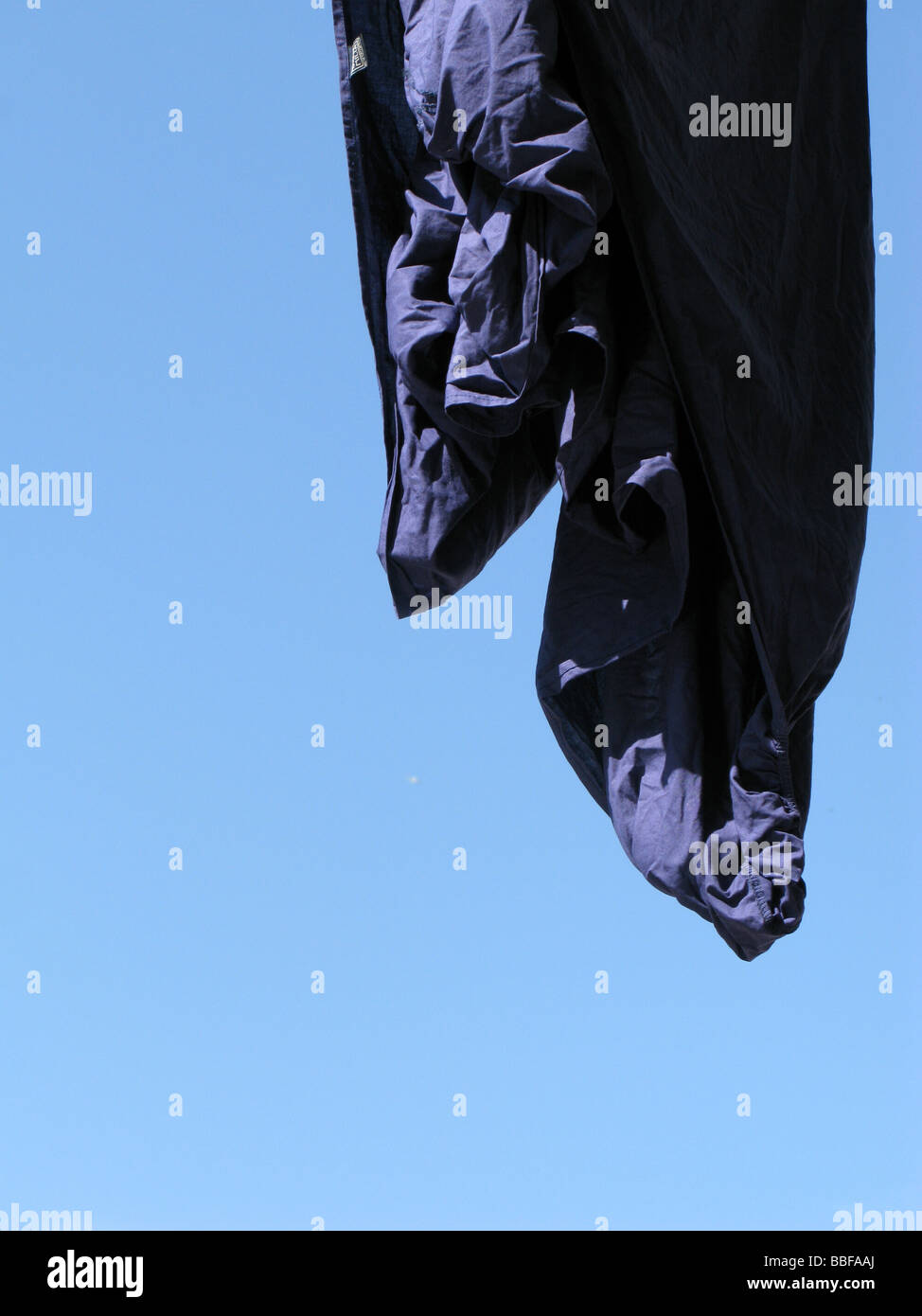 one blue bed sheet hanging on washing line in sun Stock Photo Alamy