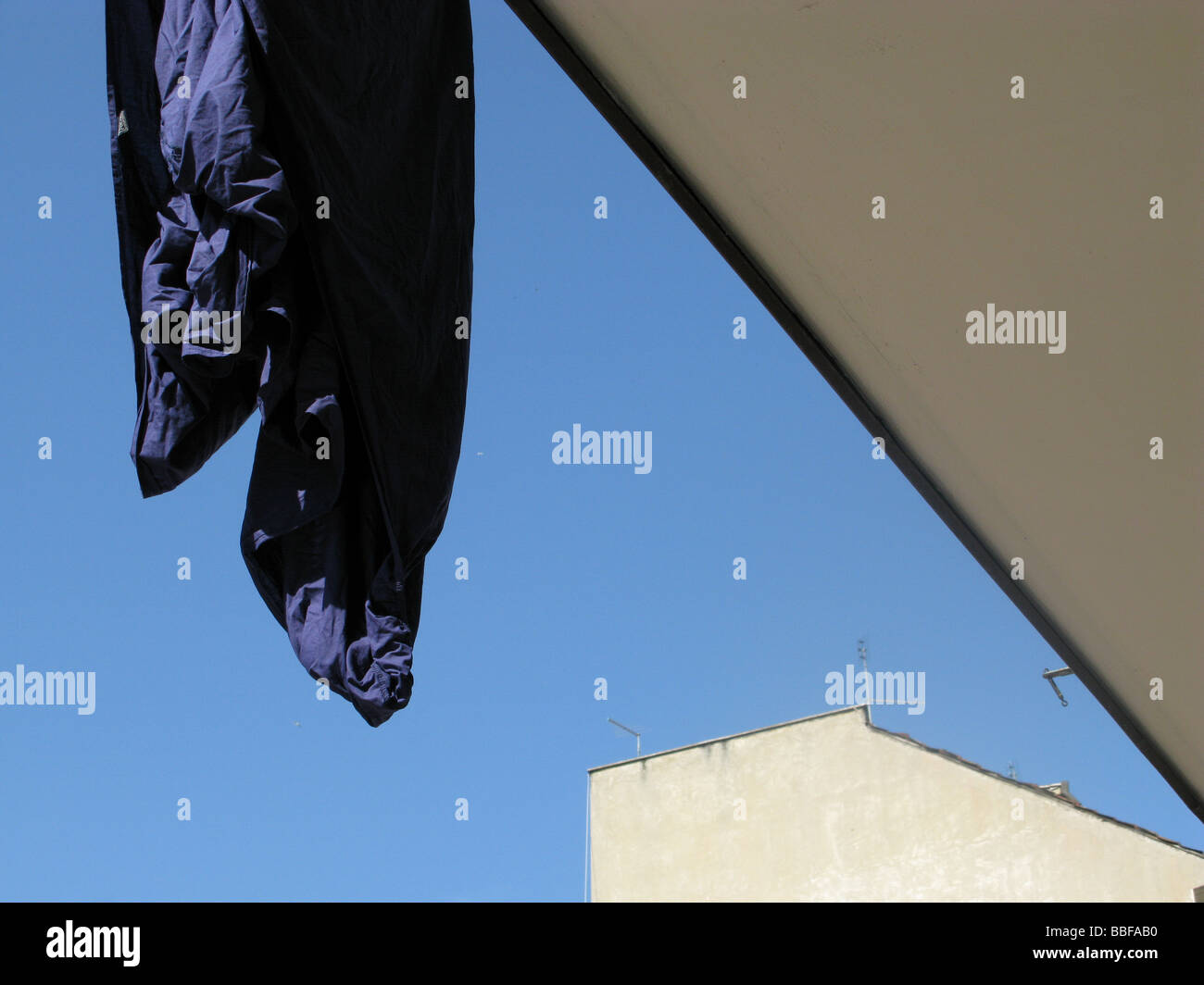 one blue bed sheet hanging on washing line in sun Stock Photo Alamy
