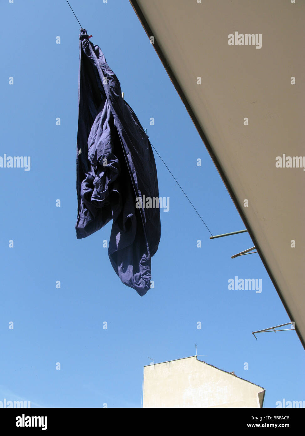 one blue bed sheet hanging on washing line in sun Stock Photo Alamy