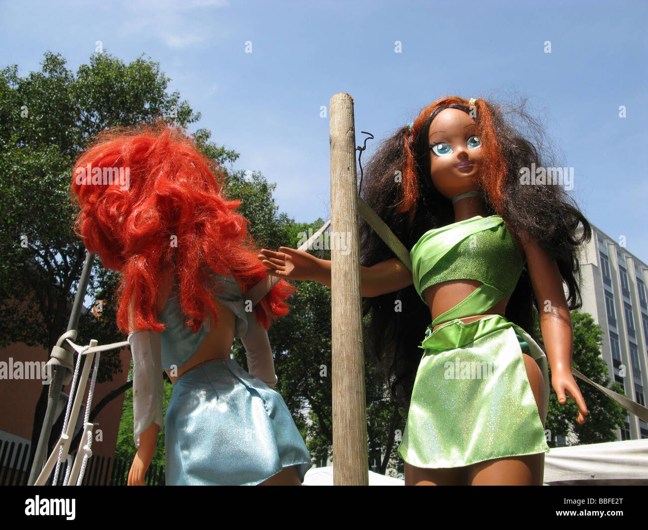 two girls dolls toys in city town street Stock Photo