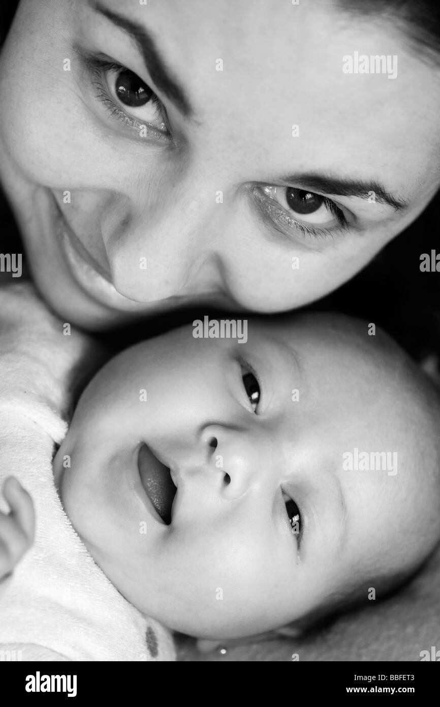 Close-up of Mother and Baby daughter smiling (B&W) - Lake San Pablo, near Otavalo, Ecuador Stock Photo
