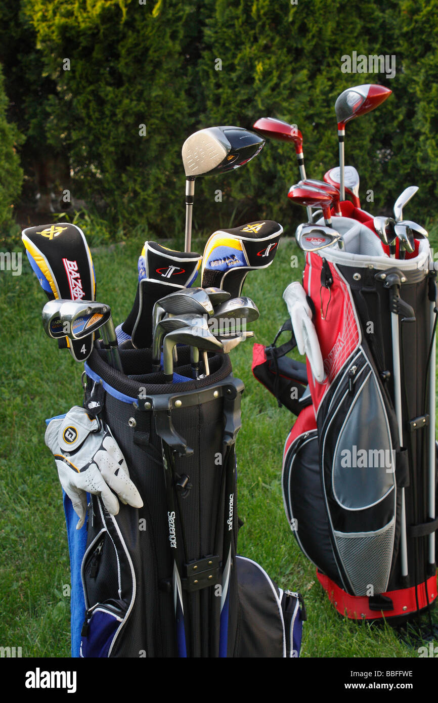 Two sets of Golf clubs in bags front view nobody close up front view outside outdoors vertical in USA US lifestyle daily life hi-res Stock Photo