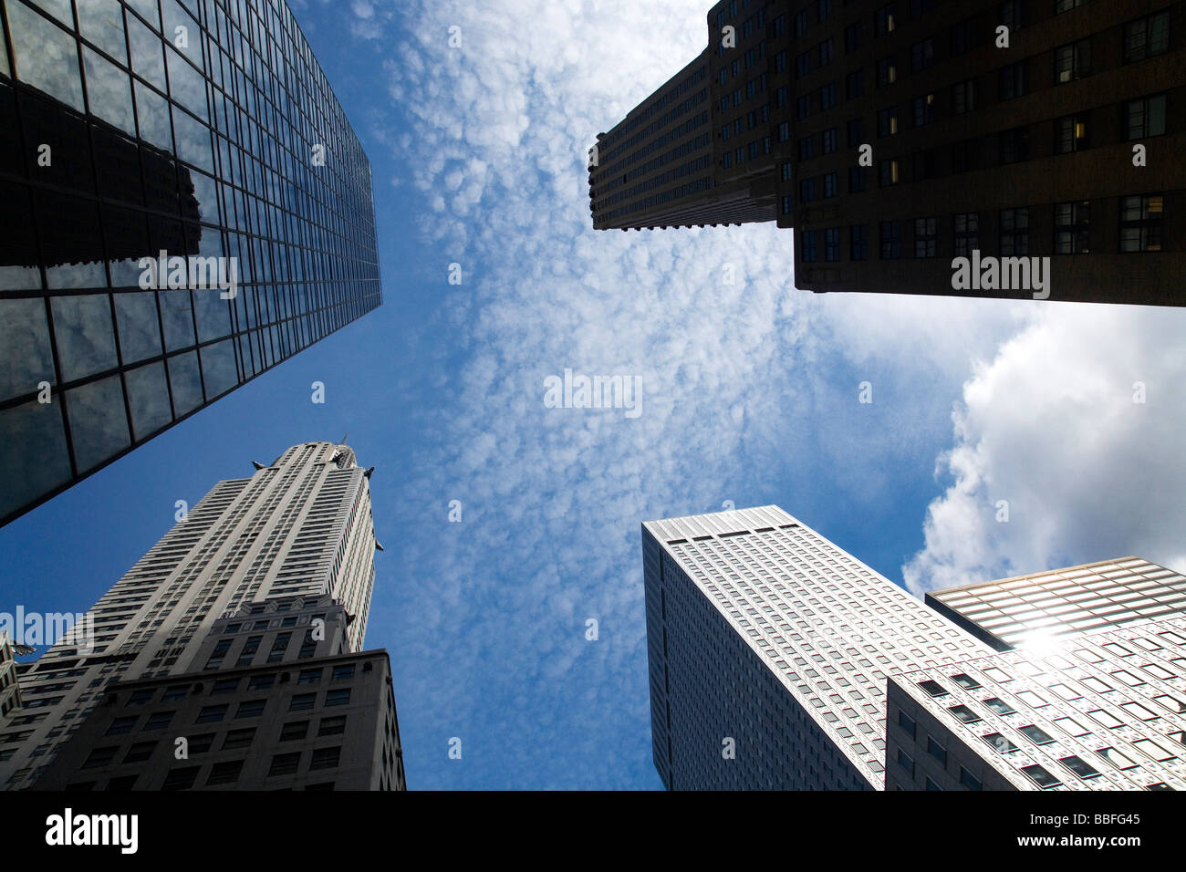 Chrysler building and other skyscrapers in spring sun sunshine blue sky midtown Manhattan New York City USA Stock Photo