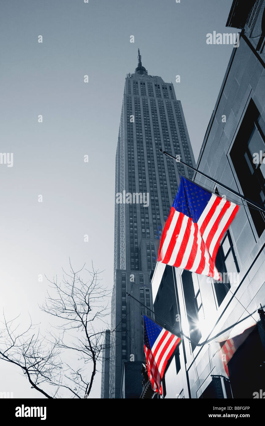 Empire State Building with stars and stripes american flags NYC USA United States of America Stock Photo