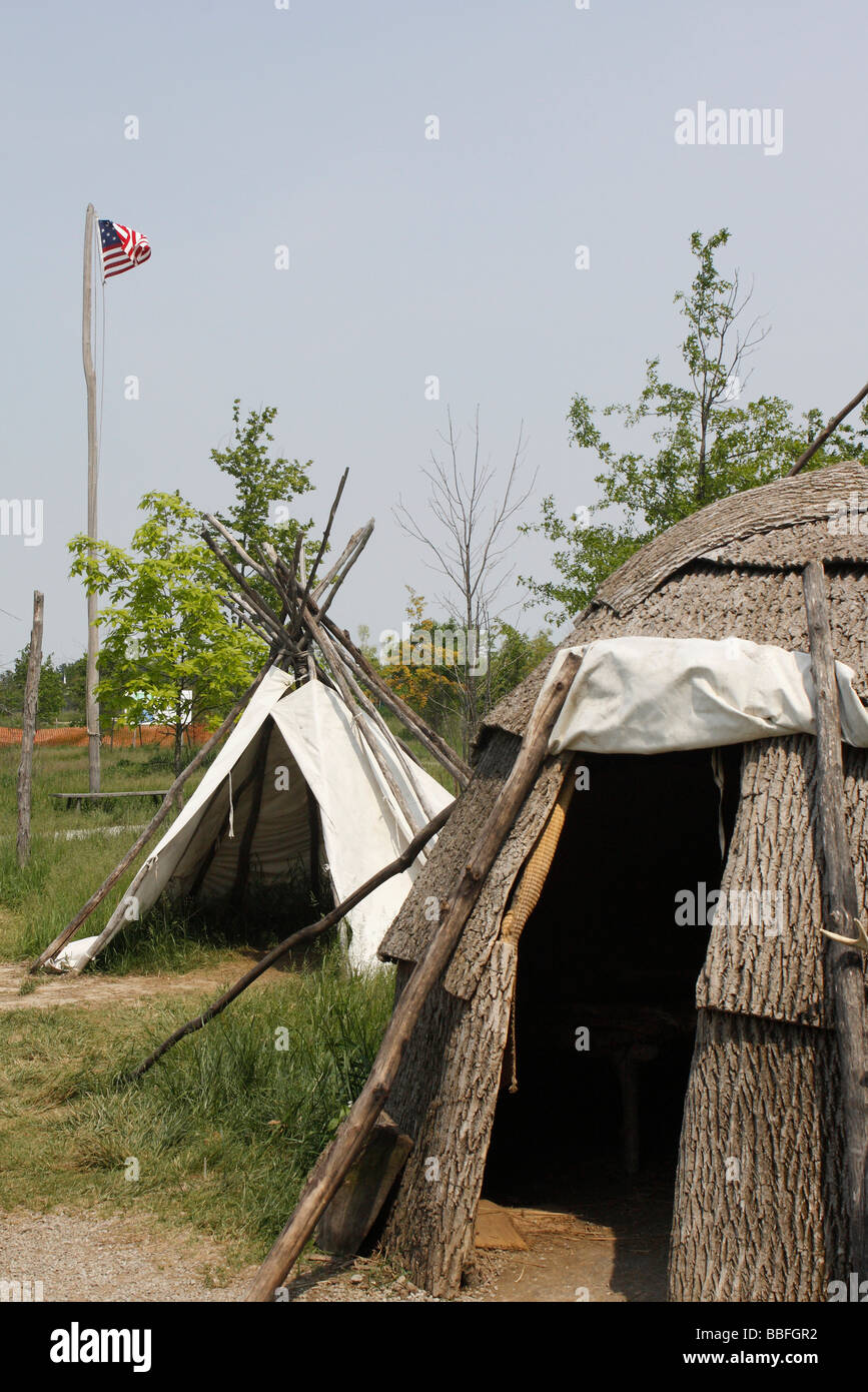 Woodland village Native Americans lived in wigwam and tepee with US flag on stand pole in Ohio USA United States vertical nobody none hi-res Stock Photo