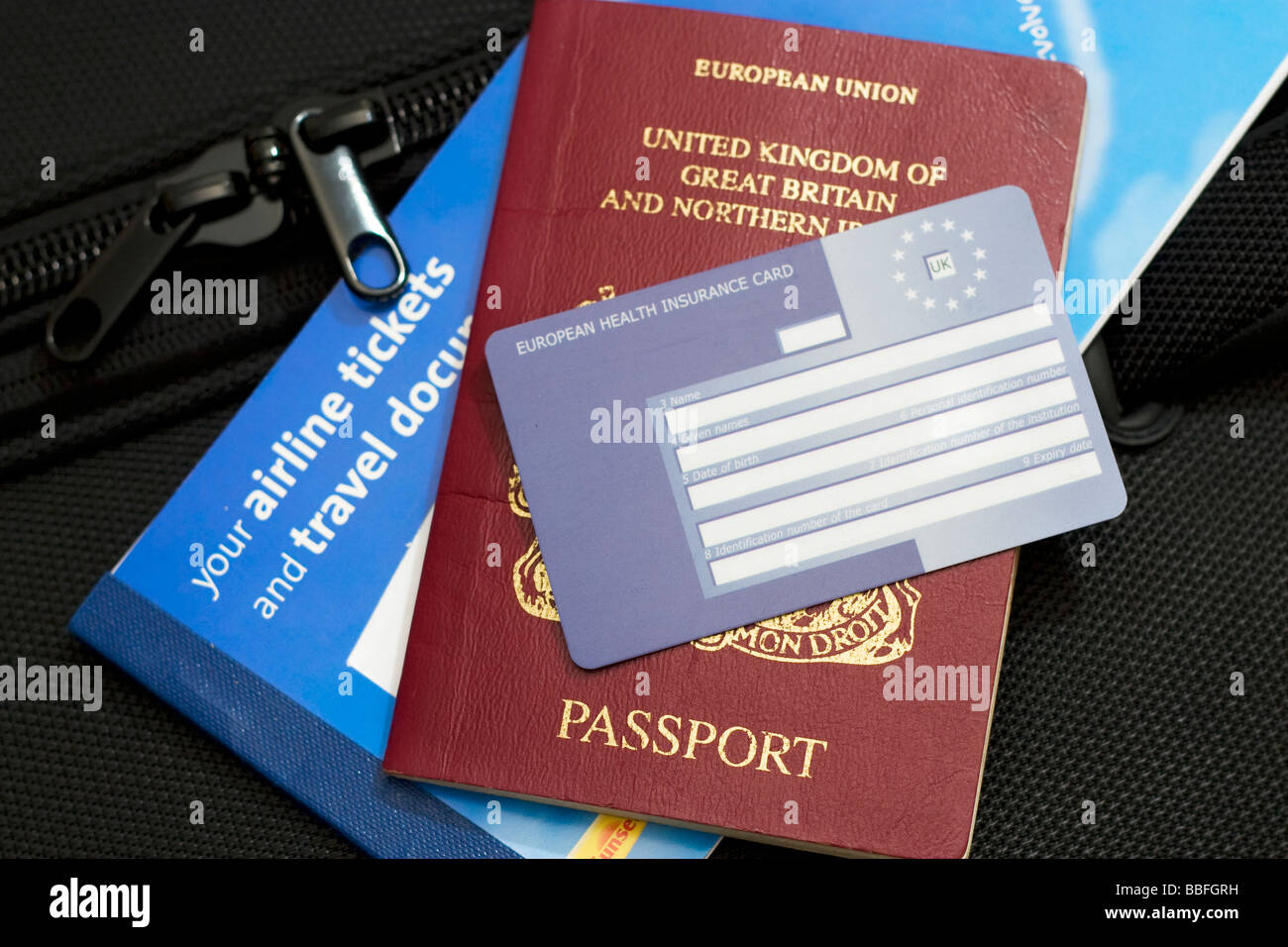 An EHIC health card, a passport and airline tickets and other travel