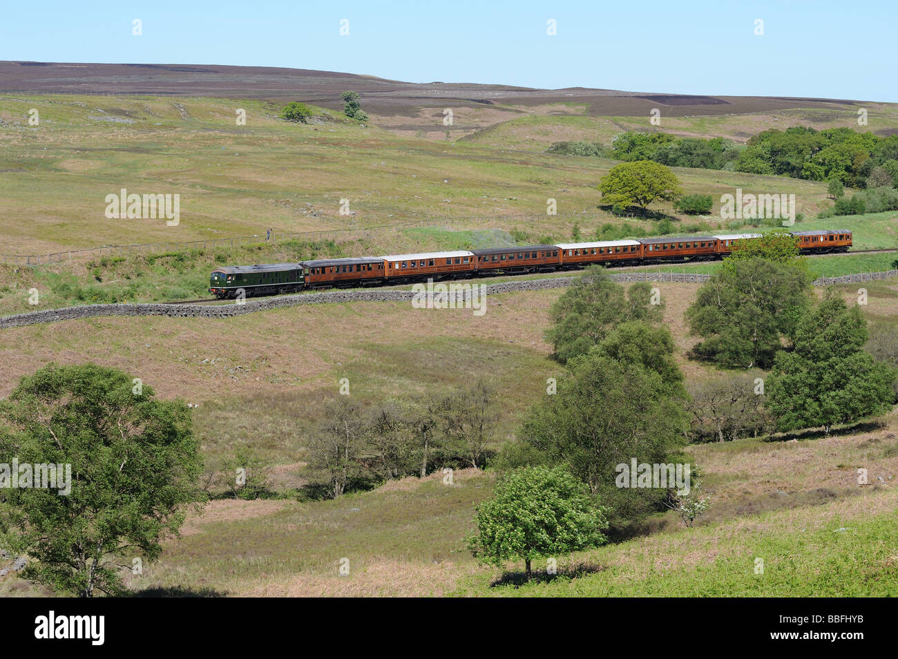 The North Yorkshire Moors Railway passes through some beautiful scenary. A  diesel train at Moorgates. Stock Photo