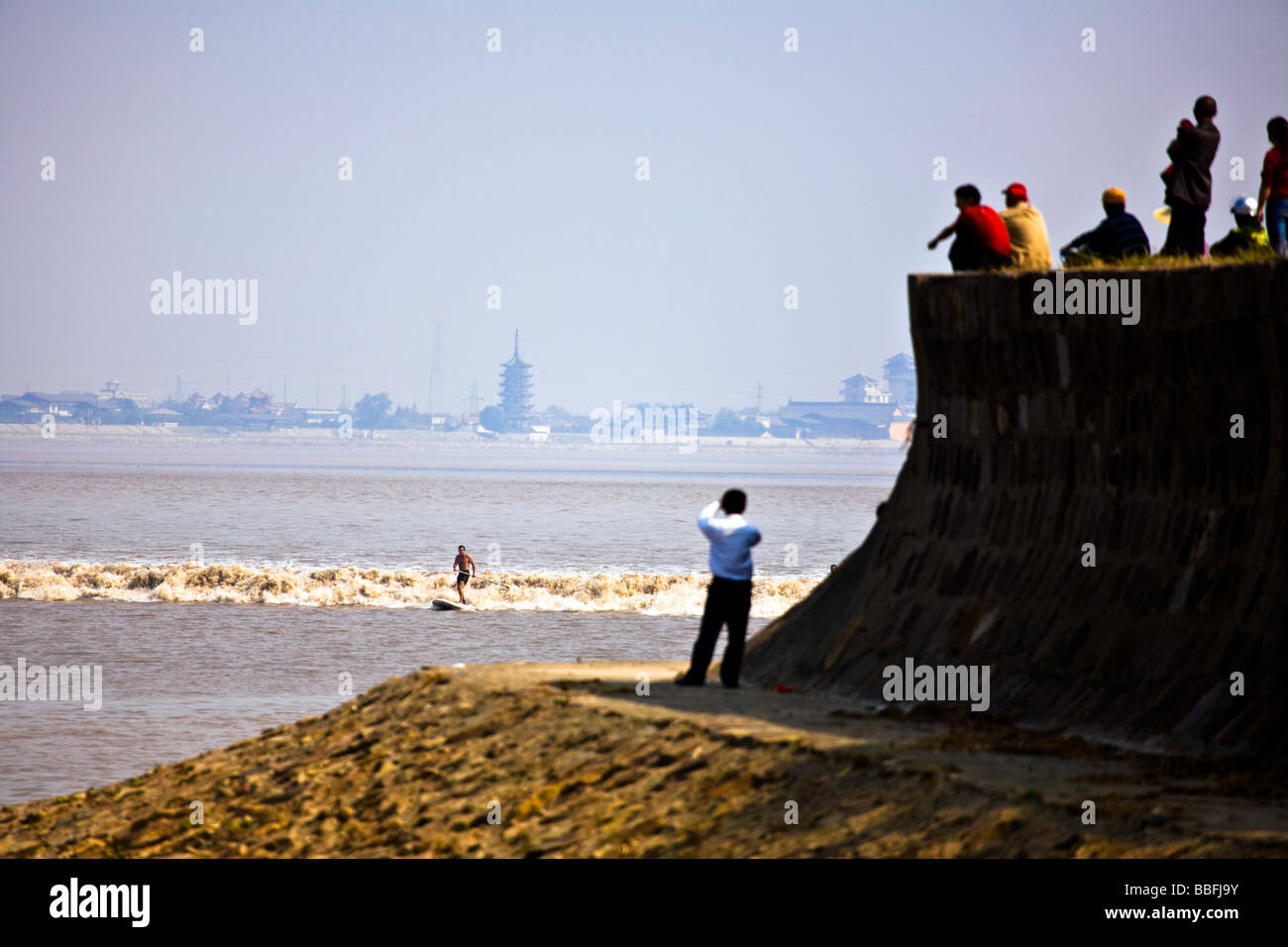 China, Zhejiang Province, Hangzhou. Qiantang River. Surfing the tidal bore, known as 'The Silver Dragon' Stock Photo