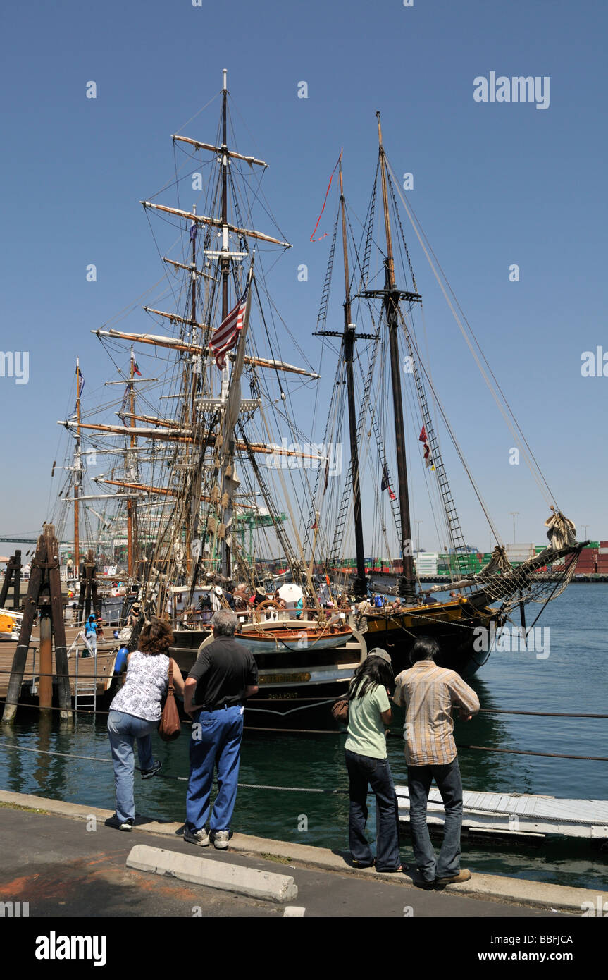 Visitors admiring the classic old style tall ships docked along the main channel of Port of Los Angeles Stock Photo