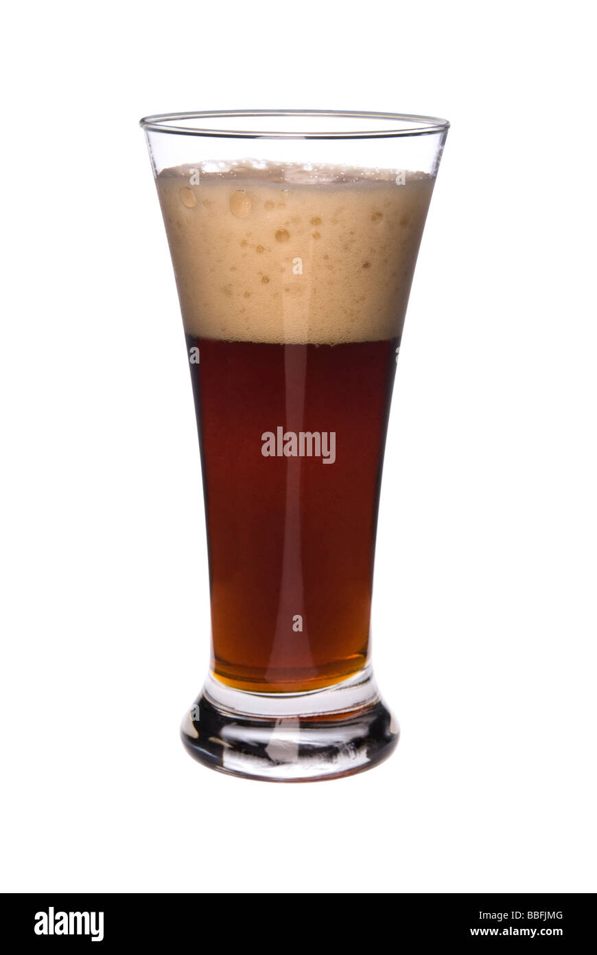 A glass of dark rich beer isolated on a white background Image was shot against a lighted white backdrop and is not a cutout Stock Photo