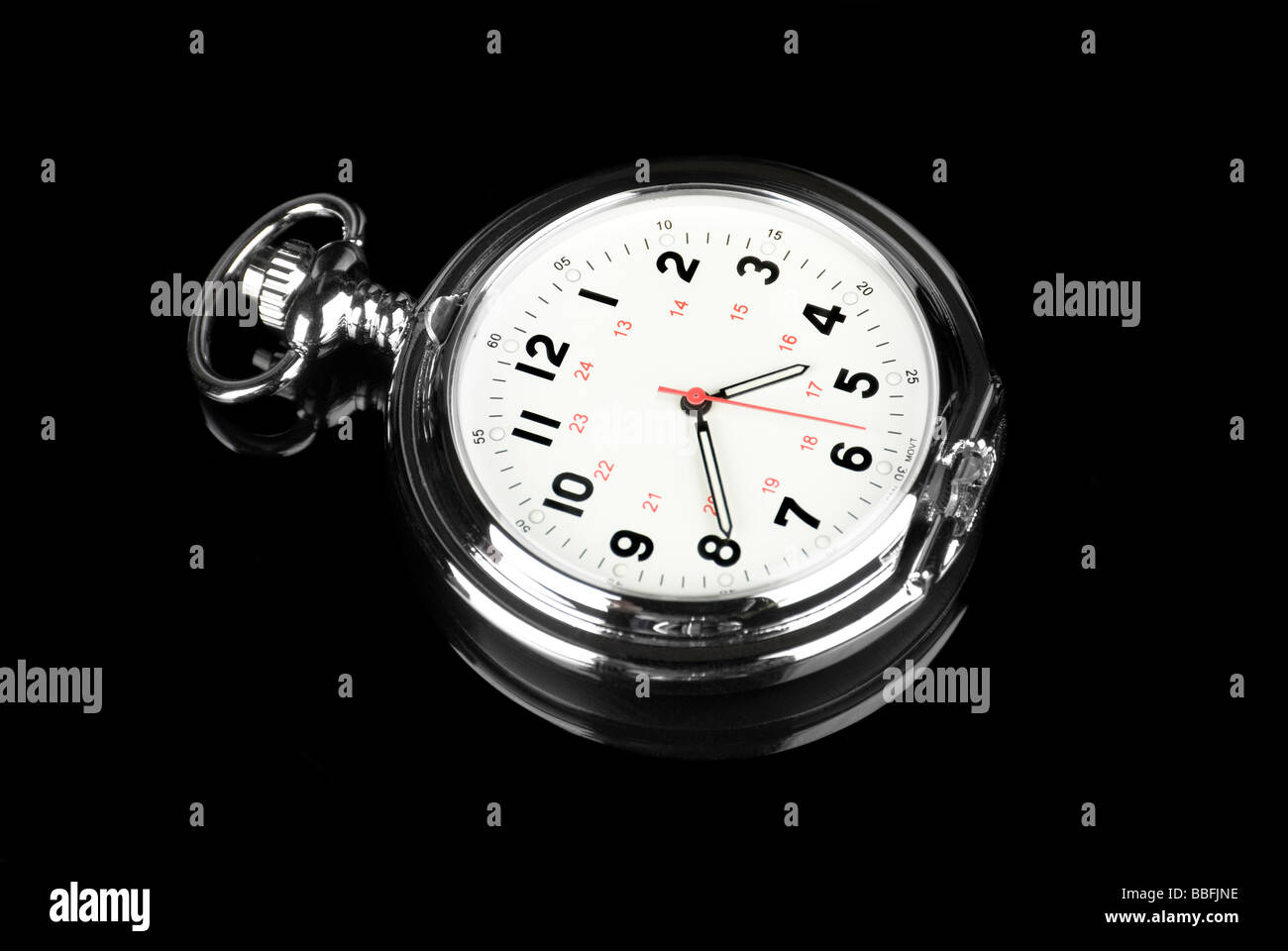 A pocket watch on a reflective black background shows it elegance and style Stock Photo