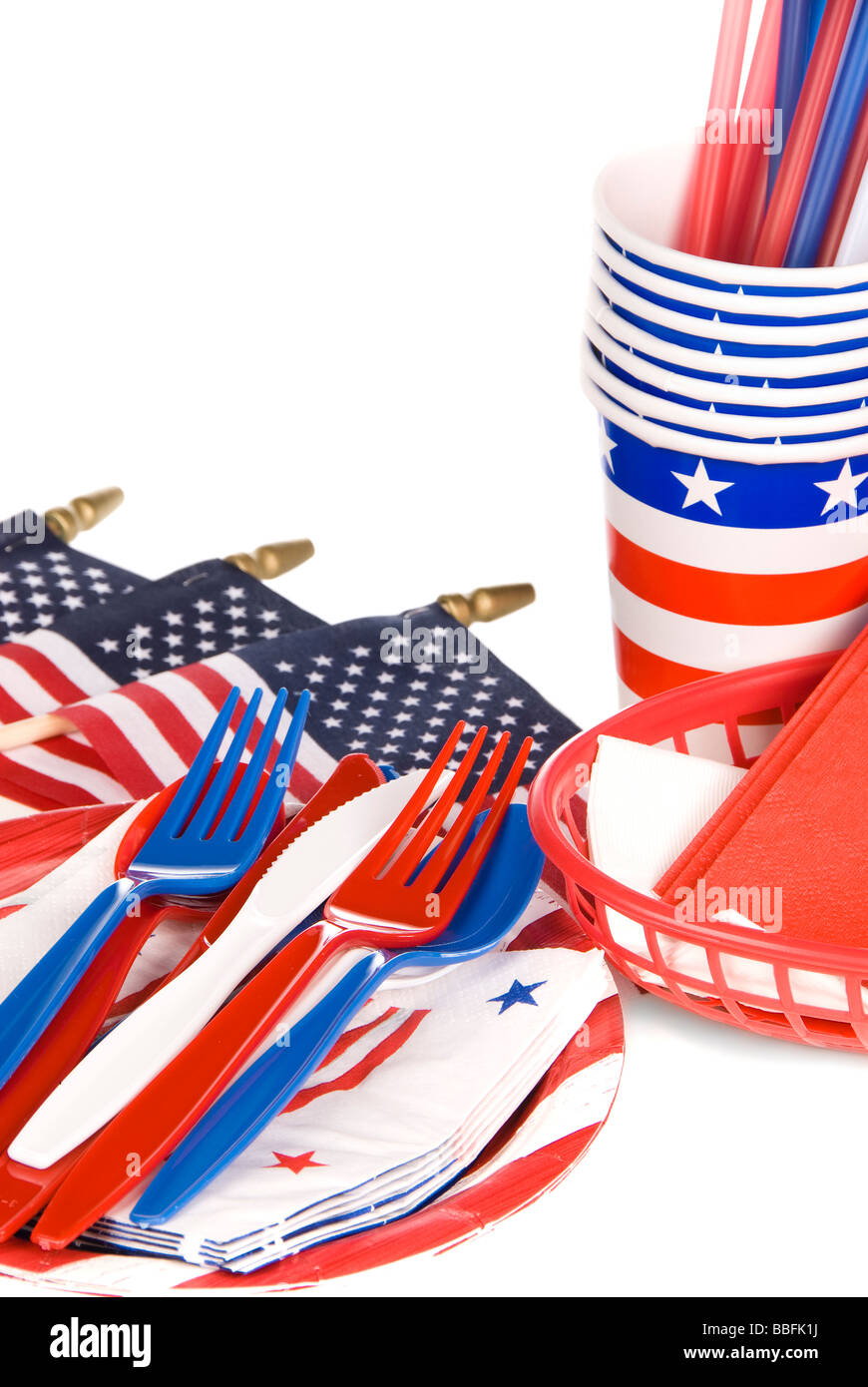 July fourth patriotic utensils including plastic forks knives spoons napkins plates and cups on a white background Stock Photo