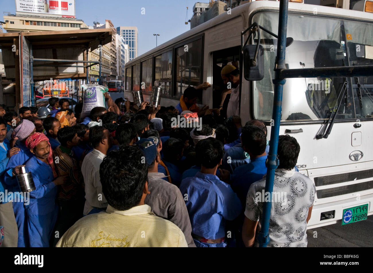 Workers taking a bus Dubai Stock Photo