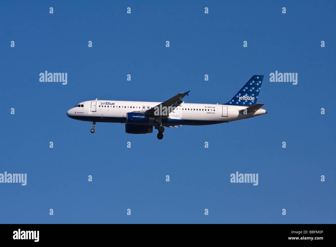 Jet Blue AIRBUS A-320 with landing gear down, 'Blue Monday' written on nose. Stock Photo