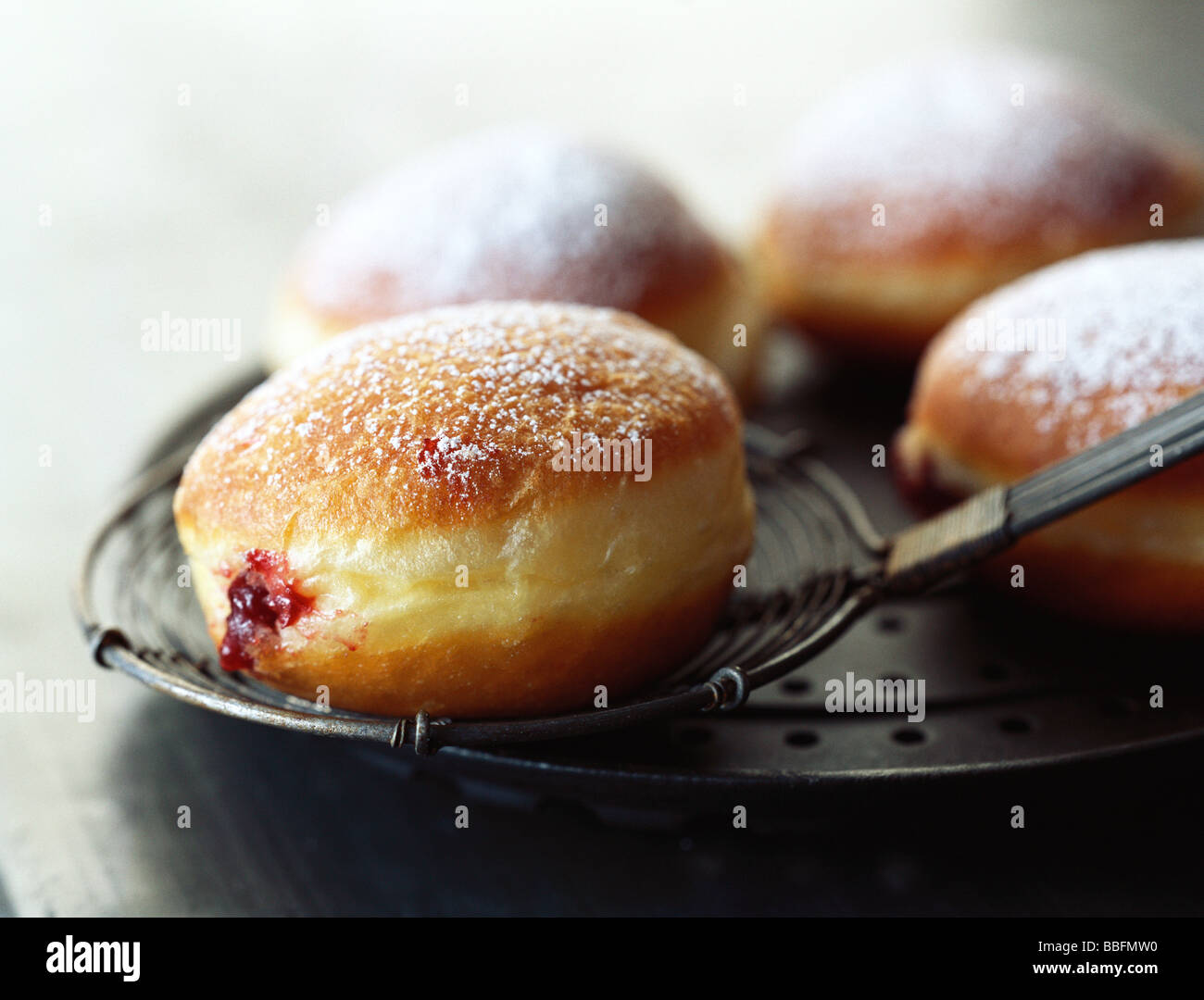 Jam filled donut dusted with powdered sugar Stock Photo