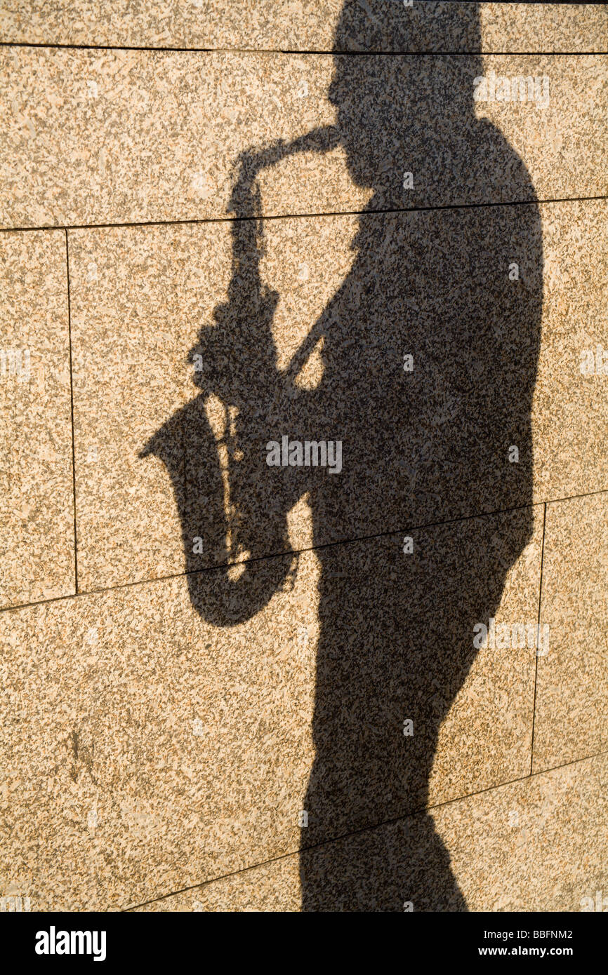 shadow of saxophone player on the street Stock Photo