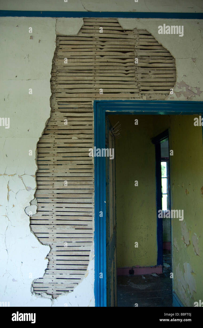 dilapidated doorway and broken plaster Stock Photo