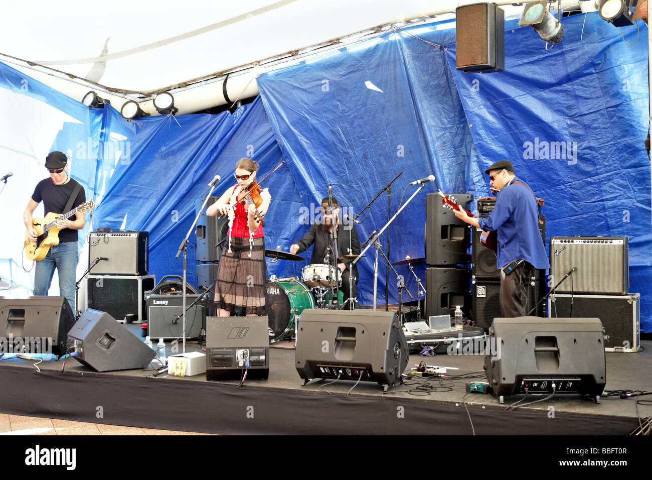 Trio of musicians playing the blues on stage Stock Photo - Alamy