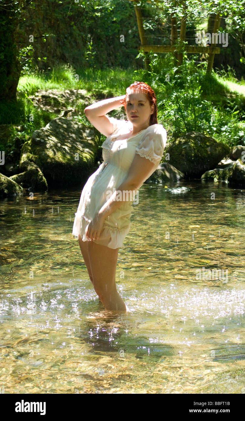 woman in white dress standing in water or river Stock Photo - Alamy