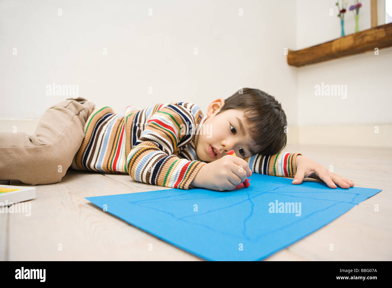 Boy holding a crayon Stock Photo Alamy