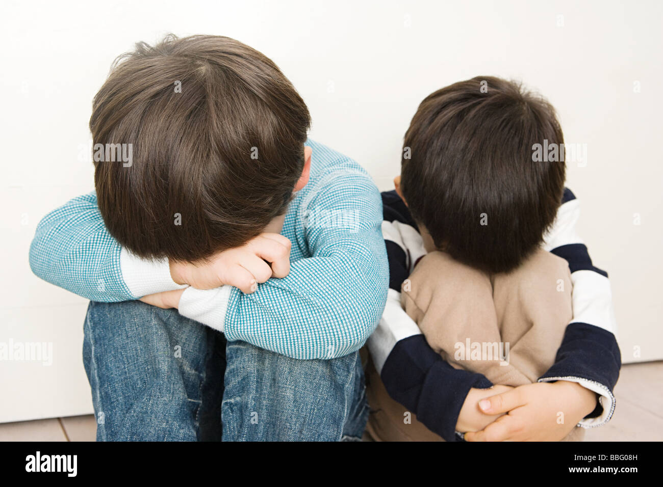 Boys covering their faces Stock Photo