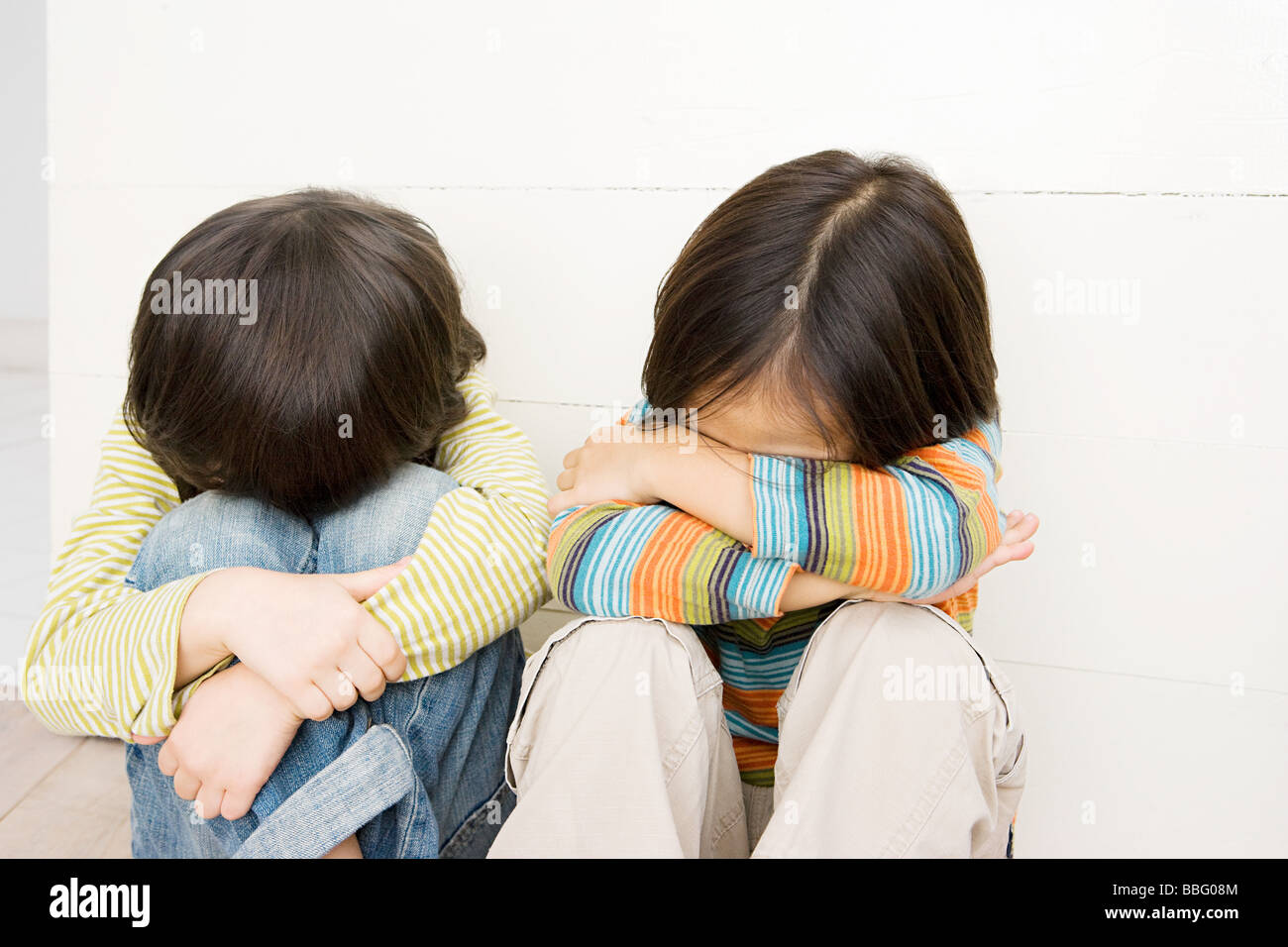 Boys covering their faces Stock Photo