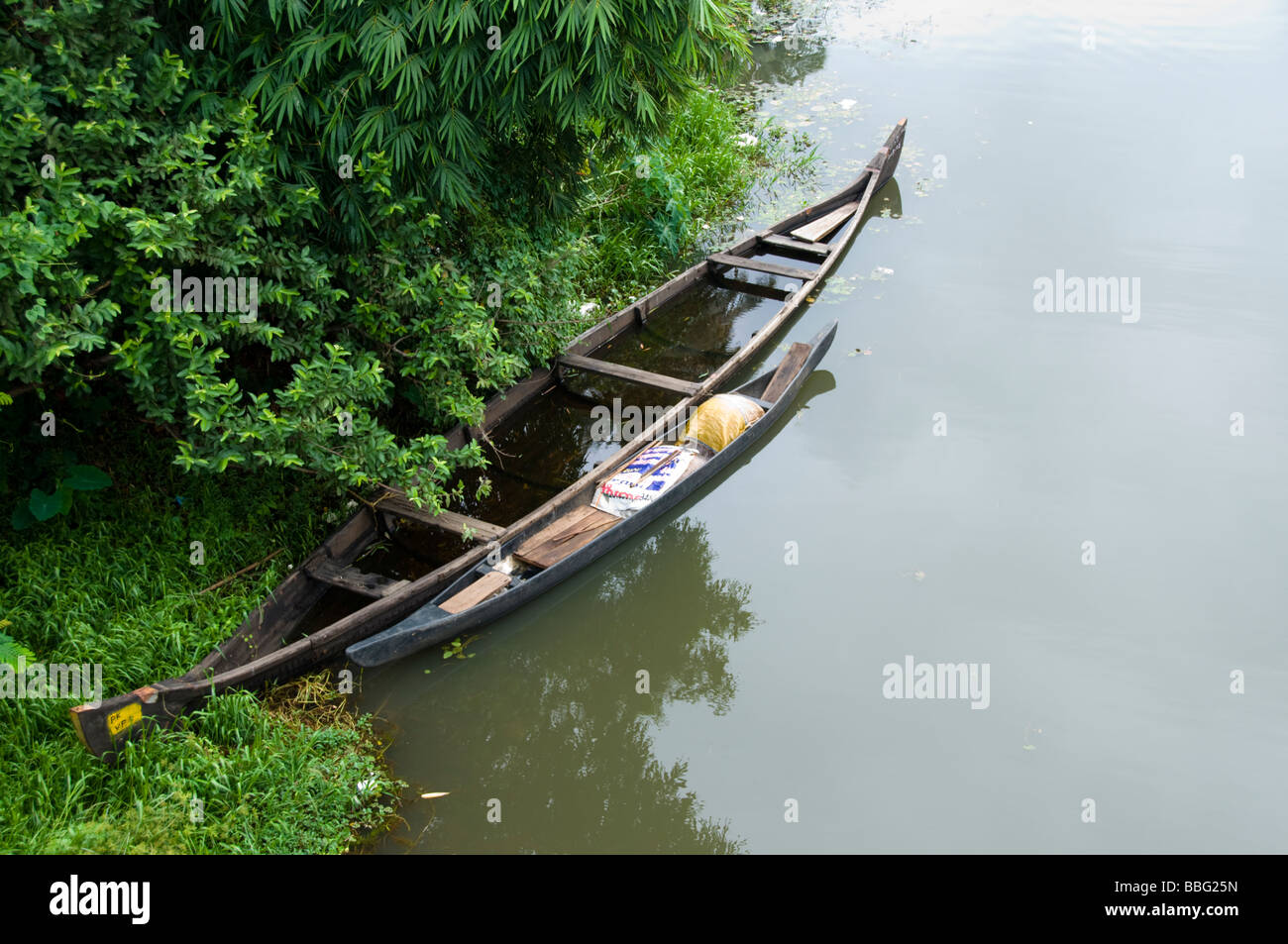 Old wooden country boat moored in backwaters of kerala india Stock Photo